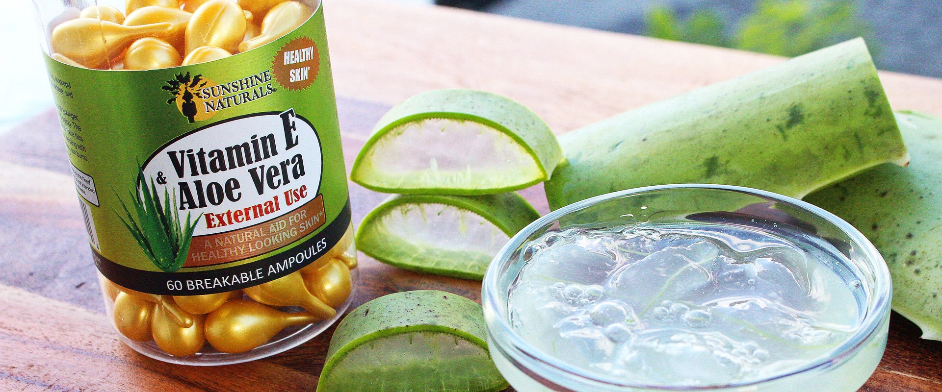 Bottle of Vitamin E alog with aloe Vera Leaves and Aloeve vera Pulp